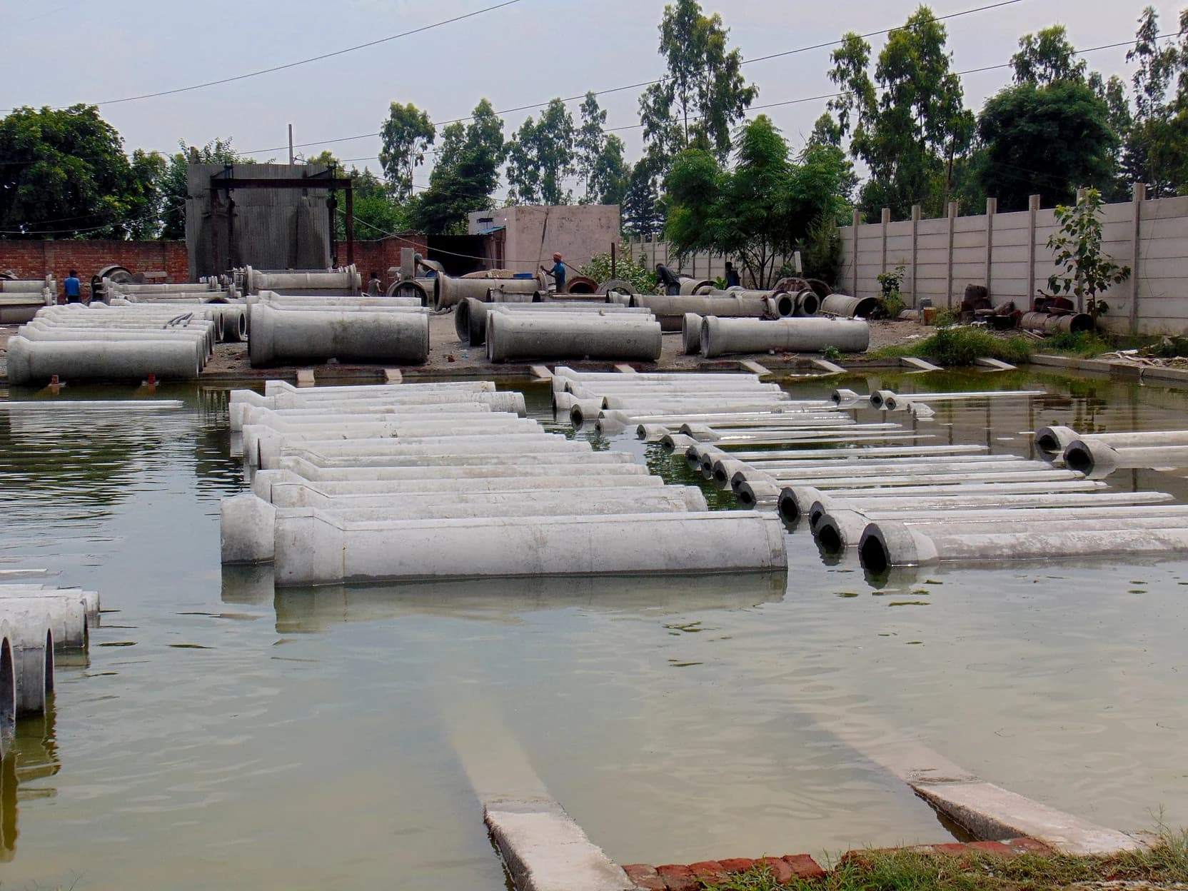 RCC pipes curing in the water yard at the KS Concrete Products plant